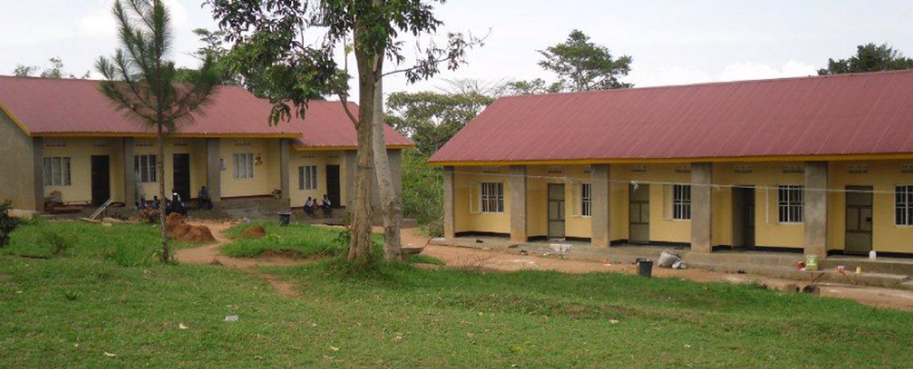 Landscape image of the school, teachers, and pupils