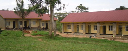 Landscape image of the school, teachers, and pupils